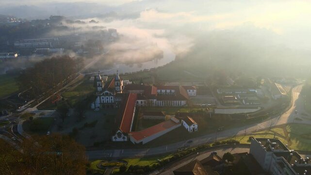 Stunning 4k drone footage of a Portugal city - Santo Tirso. View of the Abade Pedrosa Municipal Museum and the Monastery of St. Benedict (Sao Bento) with the Ave River in the background.