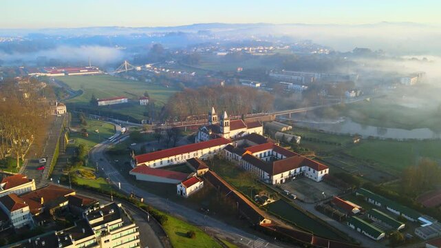Stunning 4k drone footage of a Portugal city - Santo Tirso. View of the Abade Pedrosa Municipal Museum and the Monastery of St. Benedict (Sao Bento) with the Ave River in the background.