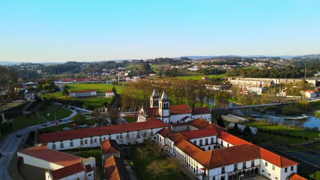 Stunning 4k drone footage of a Portugal city - Santo Tirso. View of the Abade Pedrosa Municipal Museum and the Monastery of St. Benedict (Sao Bento) with the Ave River in the background.