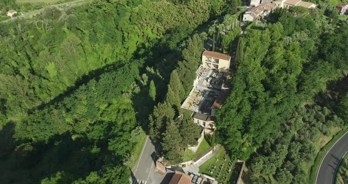 Cemetery Overlooking Townscape In Lorenzana, Crespina Lorenzana, Pisa, Tuscany, Italy. Aerial Shot