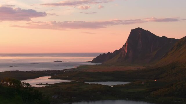 Drone reveal distant arctic Bleik Vester&aring;len village in pink sunset glow