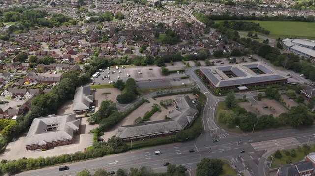 Aerial view of Peninsula Park office complex featuring modern buildings, ample parking, and surrounding greenery in Exeter, United Kingdom