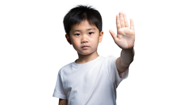 Young Boy Holds Up Hand In Stop Gesture