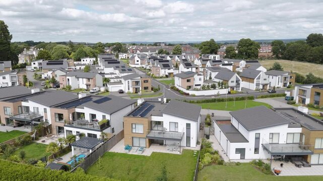 Solar panel roofs collecting energy for sustainable, renewable homes in a modern housing development in England