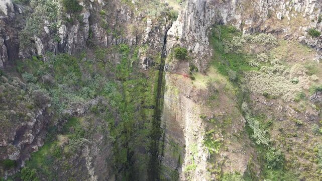 Drone approximation to Garganta Funda waterfall, Madeira. Rugged, dramatic landscape and popular spot for visitors due to its impressive drop and the stunning natural