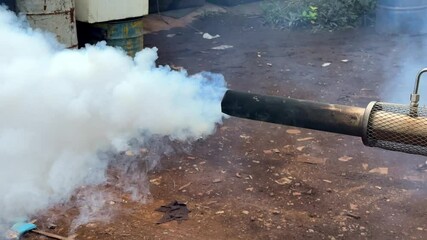 White smoke coming out of a smoke generating machine to exterminate mosquitoes