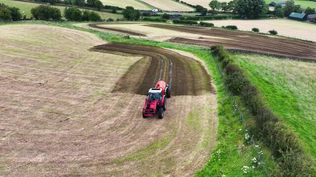 Massey Ferguson 4255 tractor and front loader with an Abbey manure slurry spreader with front loader sowing Artificial Manure fertilizer on a farm in Ireland 22-08-24
