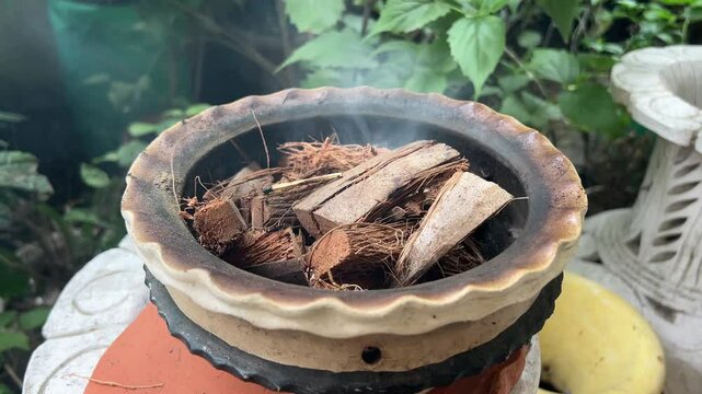 Worship of Indian god goddess idol dhoop dhuno dhunichi durga puja with narkel chobra.