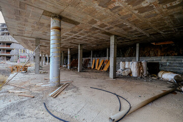 An abandoned hotel construction site on an island, surrounded by debris. A striking symbol of...
