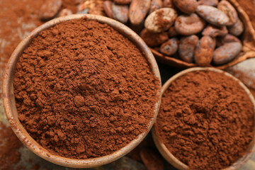 Bowls with cocoa powder on table