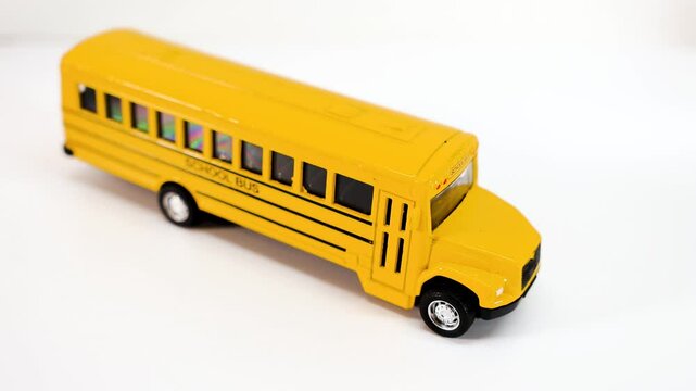 Close up view of school bus toy on white background, back to school concept.