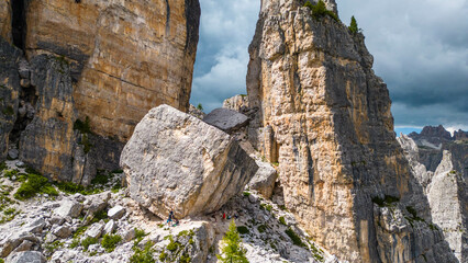 An aerial view of the incredible Cinque Torri mountains in the Dolomites, Italy, captured by a drone. This breathtaking shot showcases the dramatic rock formations and rugged beauty of  mountains