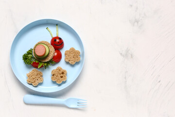 Plate with funny children's breakfast in shape of snail on white table