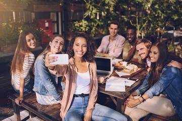 Happy people, cafe and selfie with team for photography, picture or sharing moment together at restaurant. Young, group or employees with smile for social media, memory or capture at dinner table