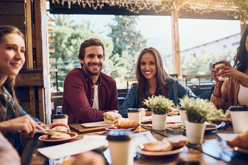 Happiness, friends and portrait in restaurant for lunch, brunch and breakfast with conversation for hangout. People, man and women with smile for social gathering, reunion or ready for eating in cafe