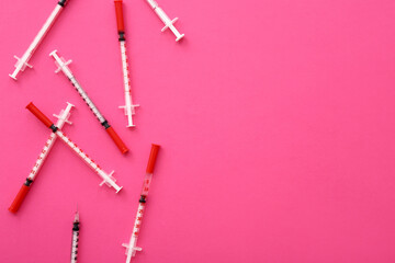 Empty syringes on pink background