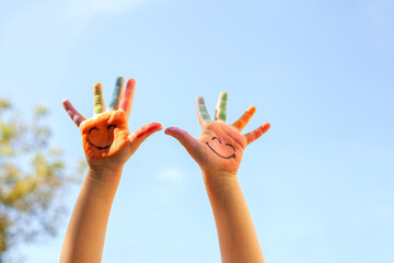 Children's painted hands with smiling faces. Happiness, joy, education, creative, school concept