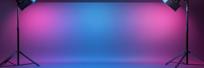 A professional photo studio setup with two lights casting vibrant blue and pink light on a seamless backdrop. The image offers ample copy space, perfect for showcasing products or showcasing creative 