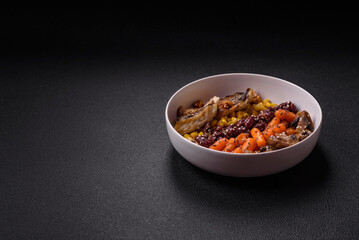 A colorful vegetarian dish consists of fish, beans, corn, mushrooms