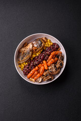 A colorful vegetarian dish consists of fish, beans, corn, mushrooms