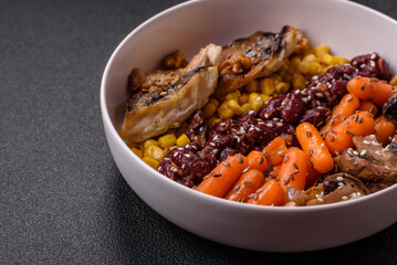 A colorful vegetarian dish consists of fish, beans, corn, mushrooms