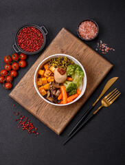 Colorful vegan vegetarian dish consists of tofu, broccoli, quinoa, mushrooms