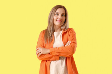 Mature woman on yellow background