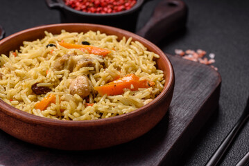 Delicious fresh pilaf with rice, carrots, meat, onions, spices and berries