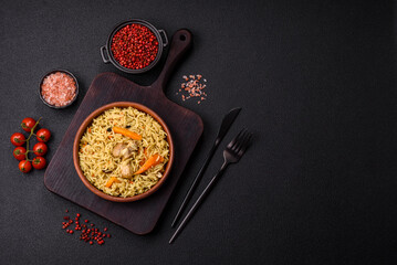 Delicious fresh pilaf with rice, carrots, meat, onions, spices and berries
