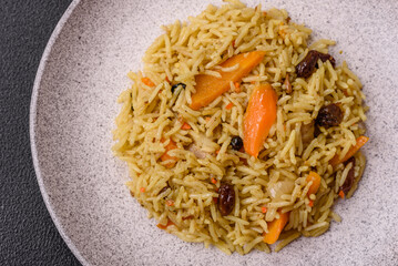 Delicious fresh pilaf with rice, carrots, meat, onions, spices and berries