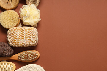 Composition with different bath sponges and massage brush on color background