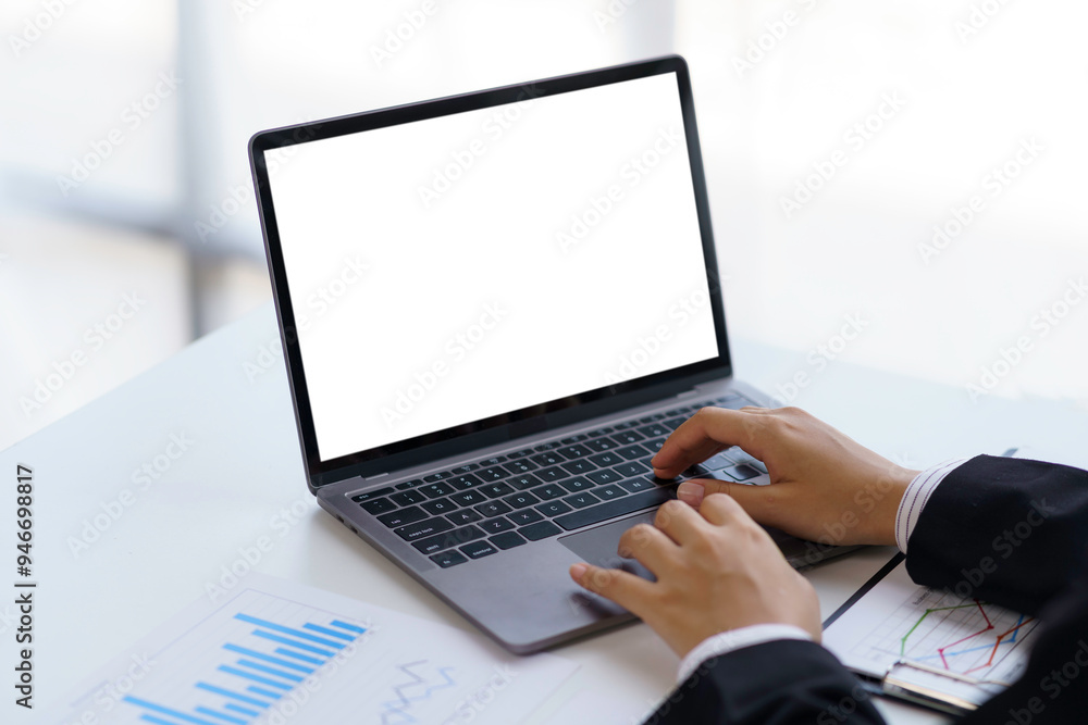 Poster businessman working with a laptop with an empty screen for your advertisement in an office environme