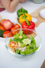 Delicious fresh salad with chicken breast being prepared on table with other fresh ingredients