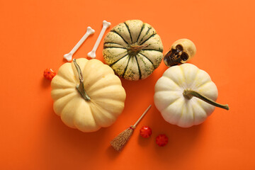 Composition with pumpkins and decorations for Halloween on color background