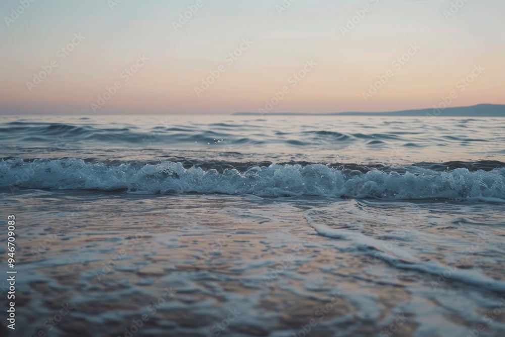 Poster a tranquil beach at sunset with soft waves crashing on the shore