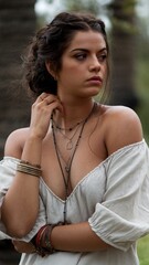 portrait of a woman in a white dress with a bracelet on her hand