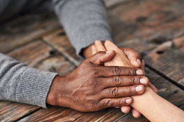 Holding hands, couple and support of people, table and kindness of love with respect, care and...