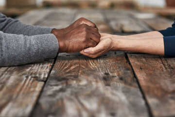 Holding hands, love and support of people, table and kindness of empathy with respect, care and...