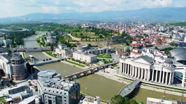 A captivating drone video of Skopje, Macedonia, showcasing the city's unique blend of historic and modern architecture, and the scenic Vardar River, highlighting the vibrant atmosphere