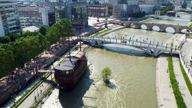 A captivating drone video of Skopje, Macedonia, showcasing the city's unique blend of historic and modern architecture, and the scenic Vardar River, highlighting the vibrant atmosphere