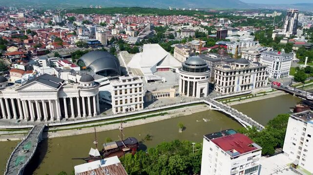 A captivating drone video of Skopje, Macedonia, showcasing the city's unique blend of historic and modern architecture, and the scenic Vardar River, highlighting the vibrant atmosphere