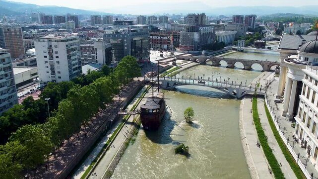 A captivating drone video of Skopje, Macedonia, showcasing the city's unique blend of historic and modern architecture, and the scenic Vardar River, highlighting the vibrant atmosphere