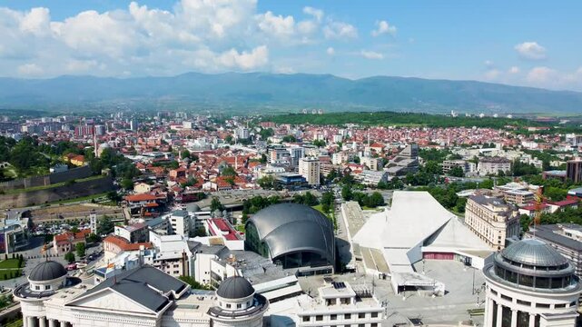 A captivating drone video of Skopje, Macedonia, showcasing the city's unique blend of historic and modern architecture, and the scenic Vardar River, highlighting the vibrant atmosphere