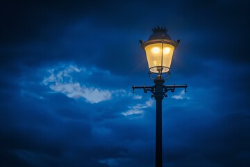 Old fashioned street lamp is standing alone, illuminating a dramatic night sky
