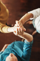 Business people, hands together and high five with team above for unity, collaboration or cooperation at office. Top view, group or employees touching for community, synergy or meeting at workplace