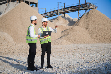 Two engineers or businessmen at an industrial plant. Plant for extraction and production of gravel