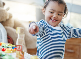Games, toddler and toys in house, smile and growth with development of child, curious and building blocks. Childhood, baby and fun for kid in home, youth and adorable in weekend, hand and learning