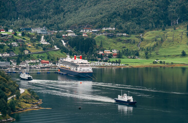 Picturesque aerial Geirangerfjord or Geirangerfjorden fjord view with Cruise ship in city port in...