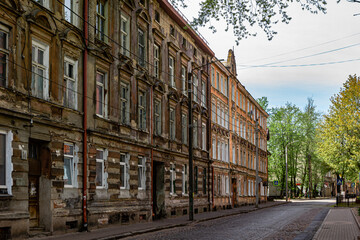 Fototapeta premium Sovetsk, Kaliningrad region, Russia, May 10, 2022 Street with old historic abandoned houses