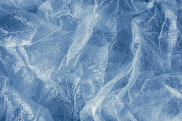 delicate background of crinkled foil in blue